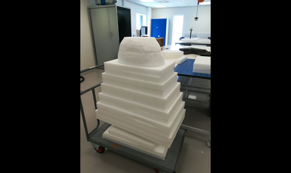 Layers of plastazote piled on top of each other to package a textile object.